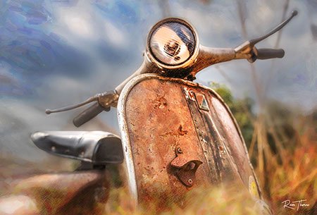 A rusting vintage Vespa scooter, partially hidden in tall weeds, reflecting years of beautiful patina.