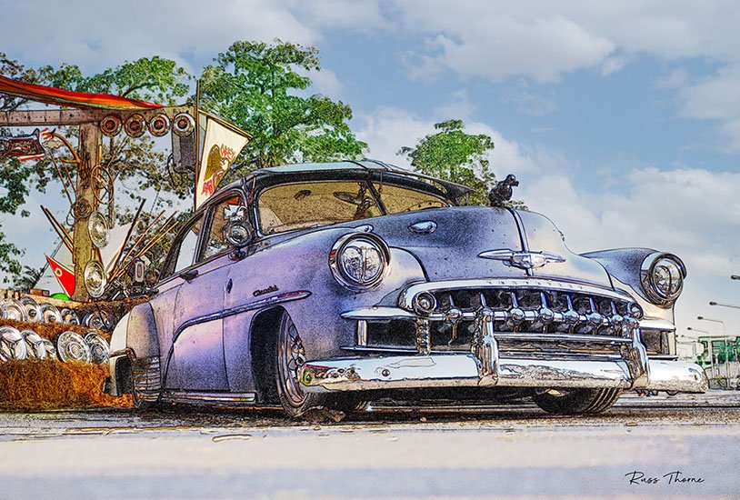 A beautifully fully restored 1940s Chevrolet sedan on display at a car show, reflecting its vintage elegance.