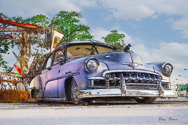 A beautifully fully restored 1940s Chevrolet sedan on display at a car show, reflecting its vintage elegance.