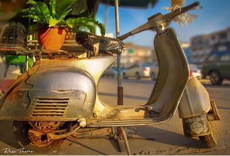 A rustic Vespa scooter, delivering eggs in Bangkok since the 1960s, exuding vintage charm and character.